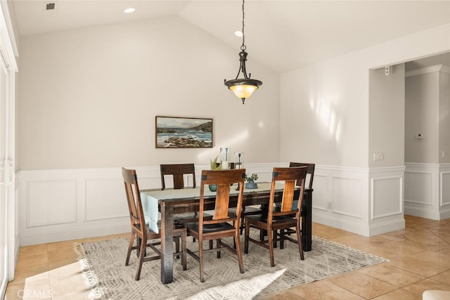 tiled dining space with lofted ceiling