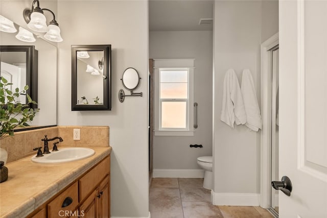 bathroom featuring toilet, vanity, and tile patterned flooring