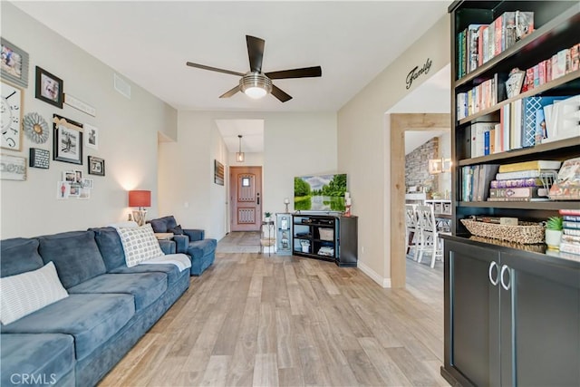 living room with ceiling fan and light wood-type flooring