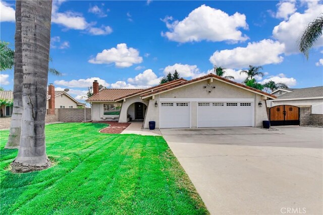 view of front of home with a garage and a front lawn