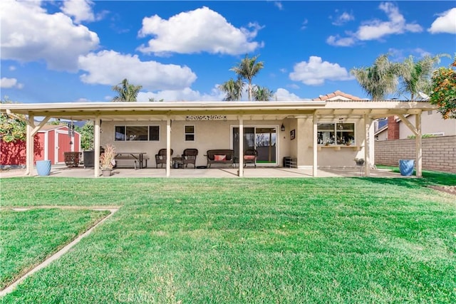 rear view of property with a storage shed, a patio area, and a lawn