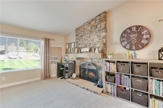 living room with lofted ceiling, a stone fireplace, and carpet flooring