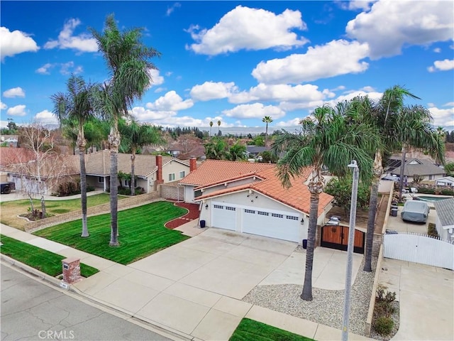 view of front of property with a garage and a front lawn