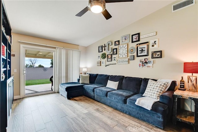 living room featuring ceiling fan and light hardwood / wood-style flooring