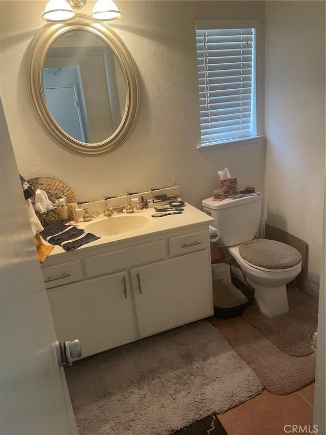 bathroom featuring toilet and vanity