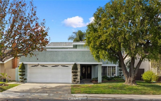 view of front of home featuring a garage and a front lawn