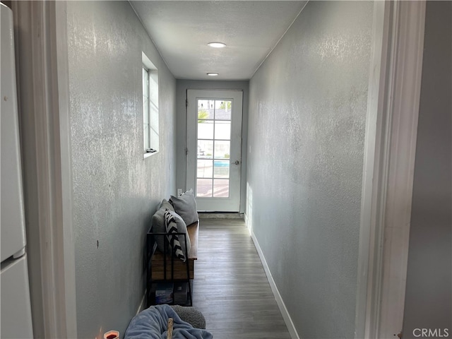 doorway featuring hardwood / wood-style flooring and a textured ceiling