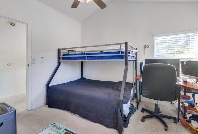 carpeted bedroom with ceiling fan and vaulted ceiling