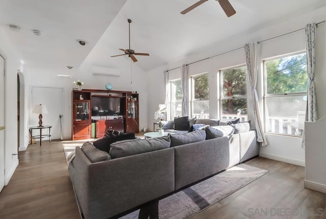 living room featuring lofted ceiling, ceiling fan, hardwood / wood-style flooring, and a wall mounted air conditioner