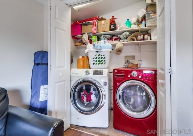 laundry area featuring wood-type flooring and washing machine and clothes dryer