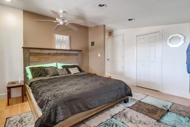 bedroom with ceiling fan, vaulted ceiling, and hardwood / wood-style floors