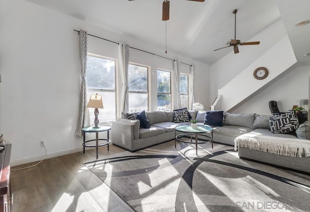 living room featuring lofted ceiling, light wood-type flooring, and ceiling fan