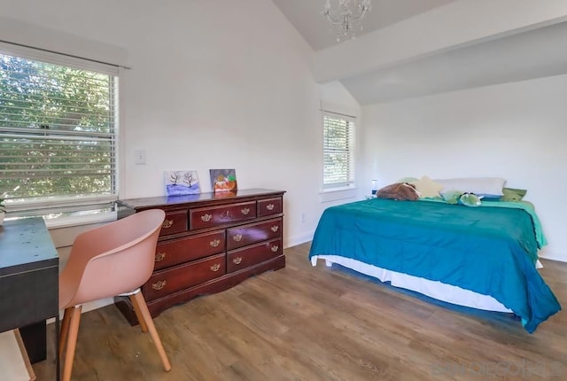 bedroom with vaulted ceiling and hardwood / wood-style floors