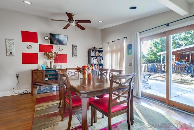 dining room featuring ceiling fan, hardwood / wood-style floors, and beamed ceiling