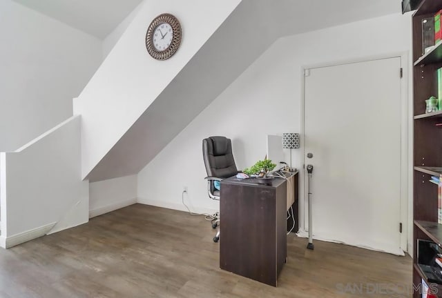 home office with dark hardwood / wood-style floors and vaulted ceiling