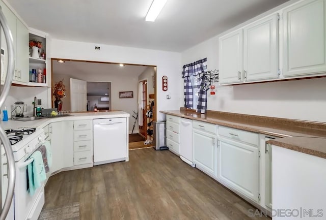 kitchen with white cabinets, kitchen peninsula, dark hardwood / wood-style floors, and white appliances