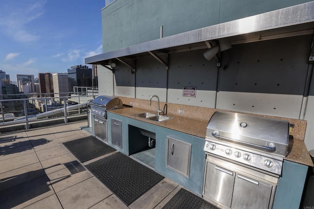 view of patio / terrace with a grill, exterior kitchen, and sink