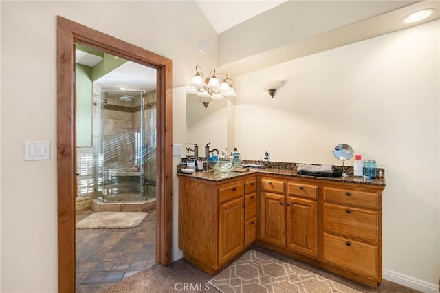 full bathroom featuring vanity, a shower stall, and baseboards