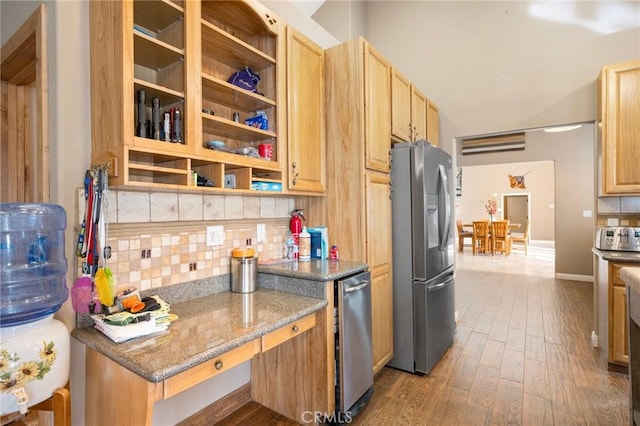 kitchen with light brown cabinets, dark wood finished floors, stone countertops, stainless steel appliances, and decorative backsplash