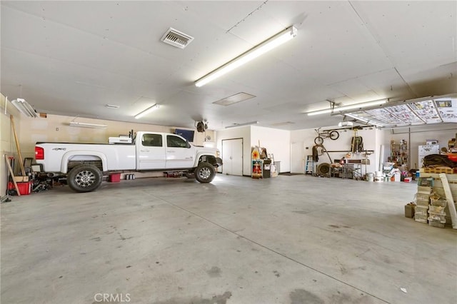 garage with visible vents and a garage door opener