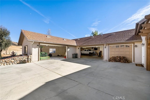 exterior space with an attached garage, driveway, and stucco siding