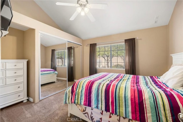 bedroom with a ceiling fan, carpet, baseboards, vaulted ceiling, and a closet