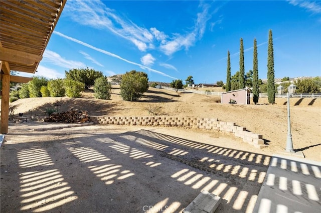 view of patio / terrace with a storage shed, an outdoor structure, and fence