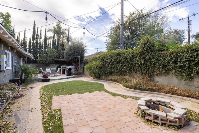 exterior space with a patio area and an outdoor fire pit