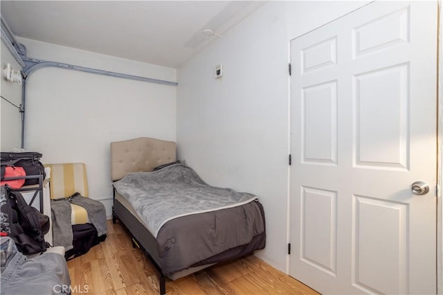 bedroom with wood-type flooring