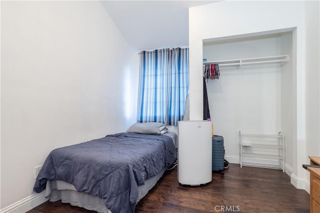 bedroom featuring a closet and dark wood-type flooring