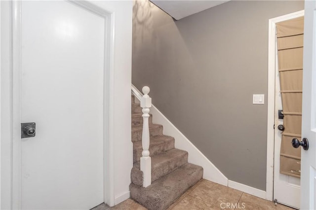 staircase with tile patterned flooring