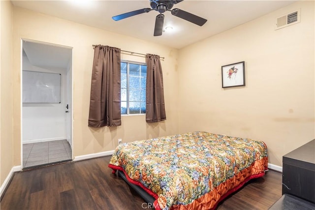 bedroom with ceiling fan and dark wood-type flooring