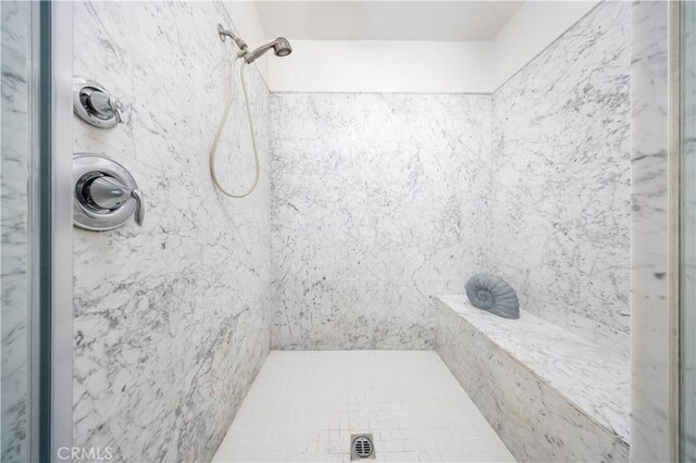 bathroom with tiled shower