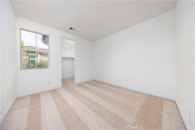 unfurnished room featuring light carpet