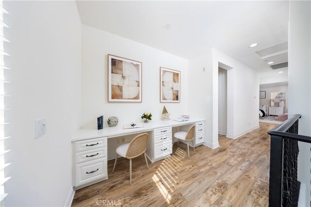 office area featuring built in desk and light hardwood / wood-style flooring