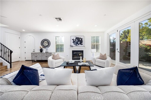 living room featuring light hardwood / wood-style floors and french doors