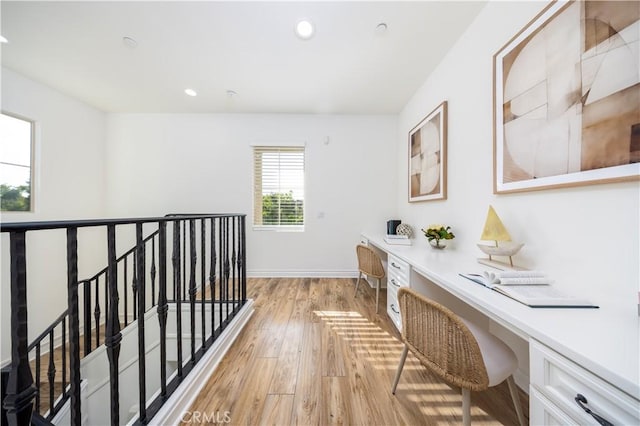 corridor with light hardwood / wood-style floors