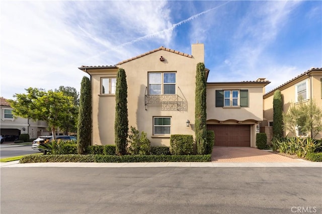 mediterranean / spanish house featuring a garage