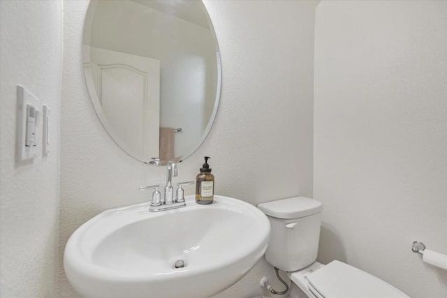 bathroom featuring toilet and sink