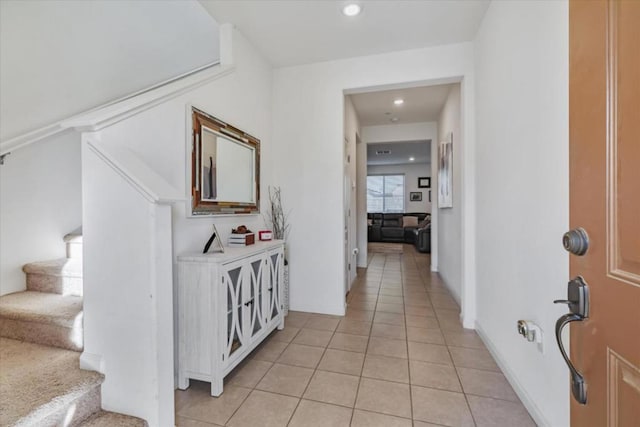 hall featuring light tile patterned flooring