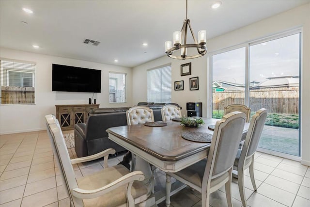 dining space featuring a notable chandelier and light tile patterned flooring