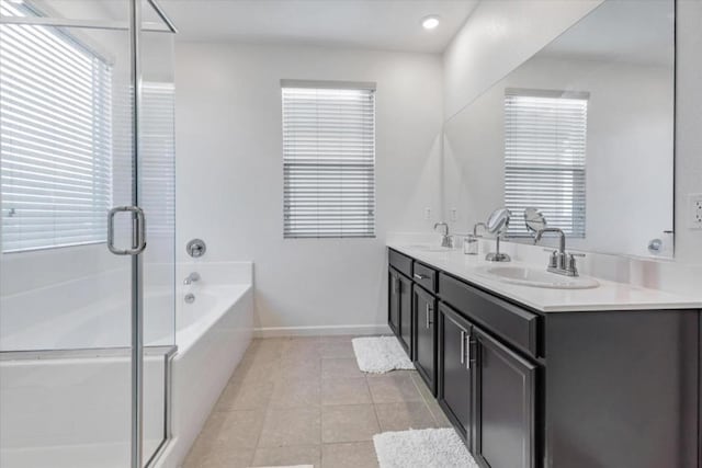 bathroom with vanity, tile patterned flooring, and plus walk in shower