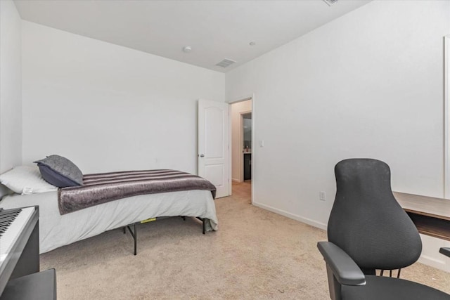 bedroom featuring light carpet