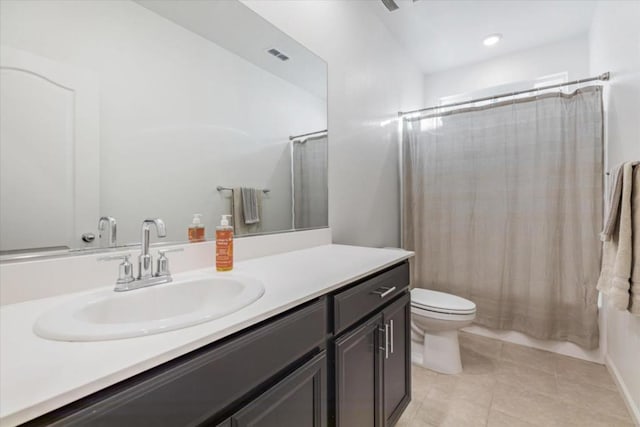 full bathroom with shower / bath combo with shower curtain, tile patterned floors, vanity, and toilet