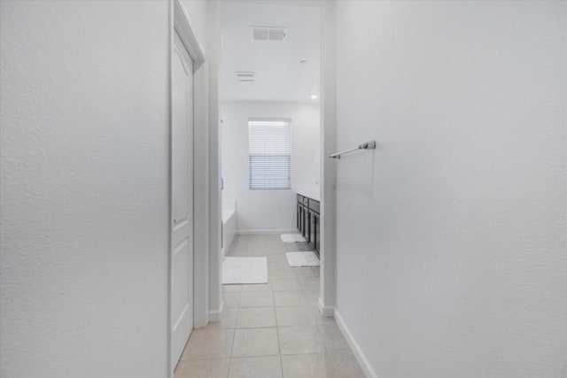 hall featuring light tile patterned floors