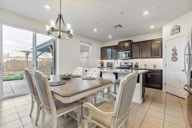 dining space with a notable chandelier and light tile patterned flooring