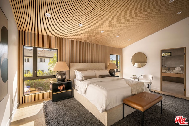 bedroom featuring vaulted ceiling, wooden ceiling, ensuite bathroom, and light hardwood / wood-style floors