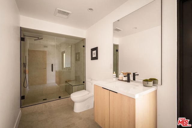 bathroom featuring toilet, tile patterned flooring, walk in shower, and vanity