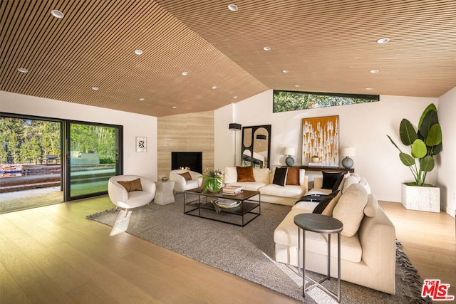 living room with wooden ceiling, hardwood / wood-style floors, and lofted ceiling