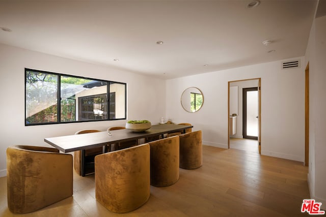 dining area featuring a wealth of natural light and light hardwood / wood-style flooring